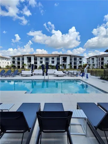 a view of a patio with swimming pool table and chairs