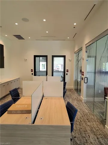 a large bedroom with wooden floor and bed