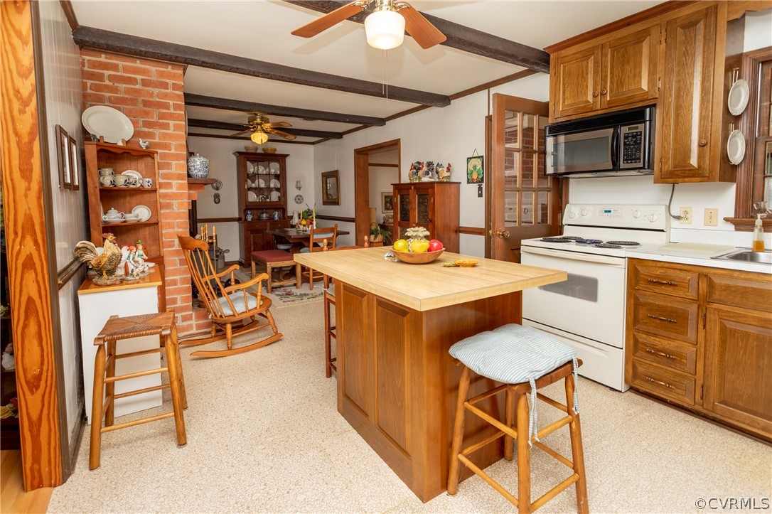 2619 Manakin Road Manakin-Sabot, VA 23103 - Photo 22 of 32 a open kitchen with stainless steel appliances granite countertop a stove top oven a sink a dining table and chairs with wooden floor