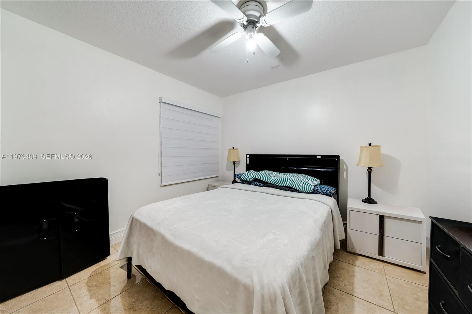 13050 Southwest 26th Street Miami, FL 33175 - Photo 25 of 43 a bedroom with a bed and a ceiling fan