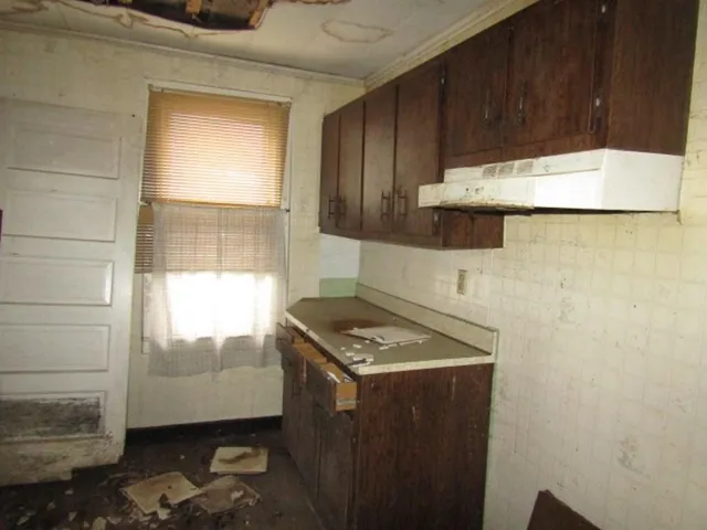 a kitchen with a sink a stove and cabinets