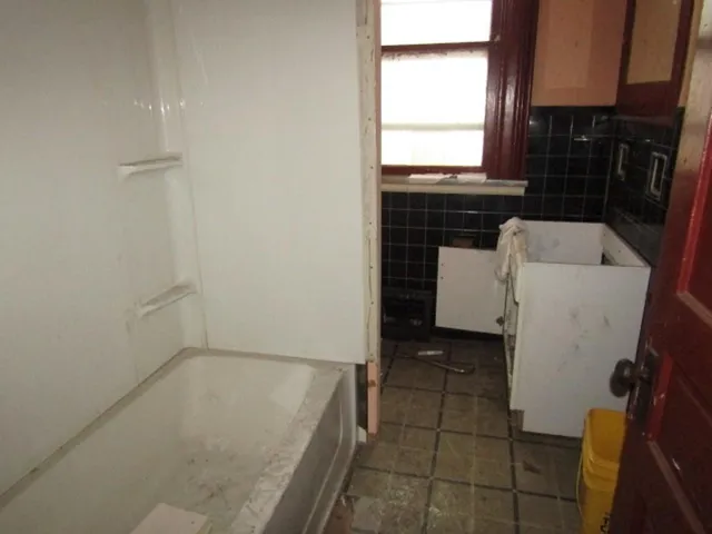 a bathroom with a bathtub sink and window
