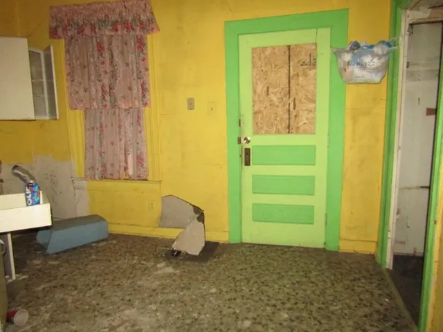 a living room with a couch and a dresser next to a window