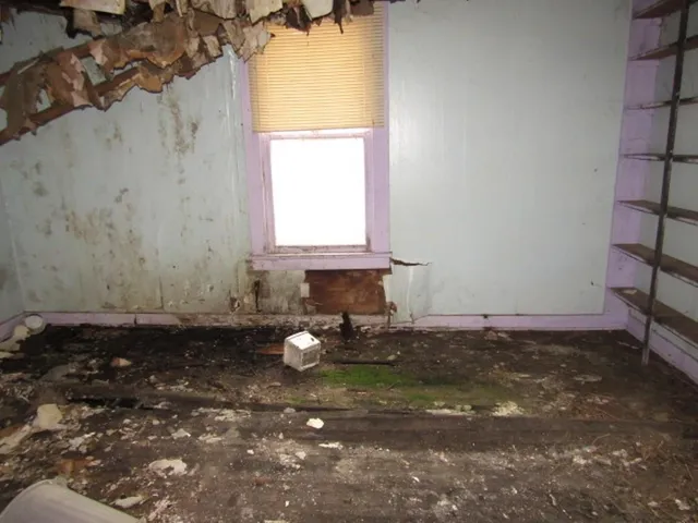 a view of a room with rack on the wall and a window