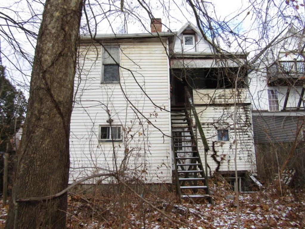 500 East 2nd Avenue Tarentum, PA 15084 - Photo 4 of 30 a brick house with a small yard and large trees