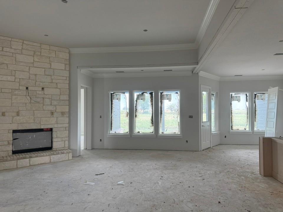 2305 Quartz Street Krum, TX 76249 - Photo 6 of 18 a view of an empty room with a fireplace and a window