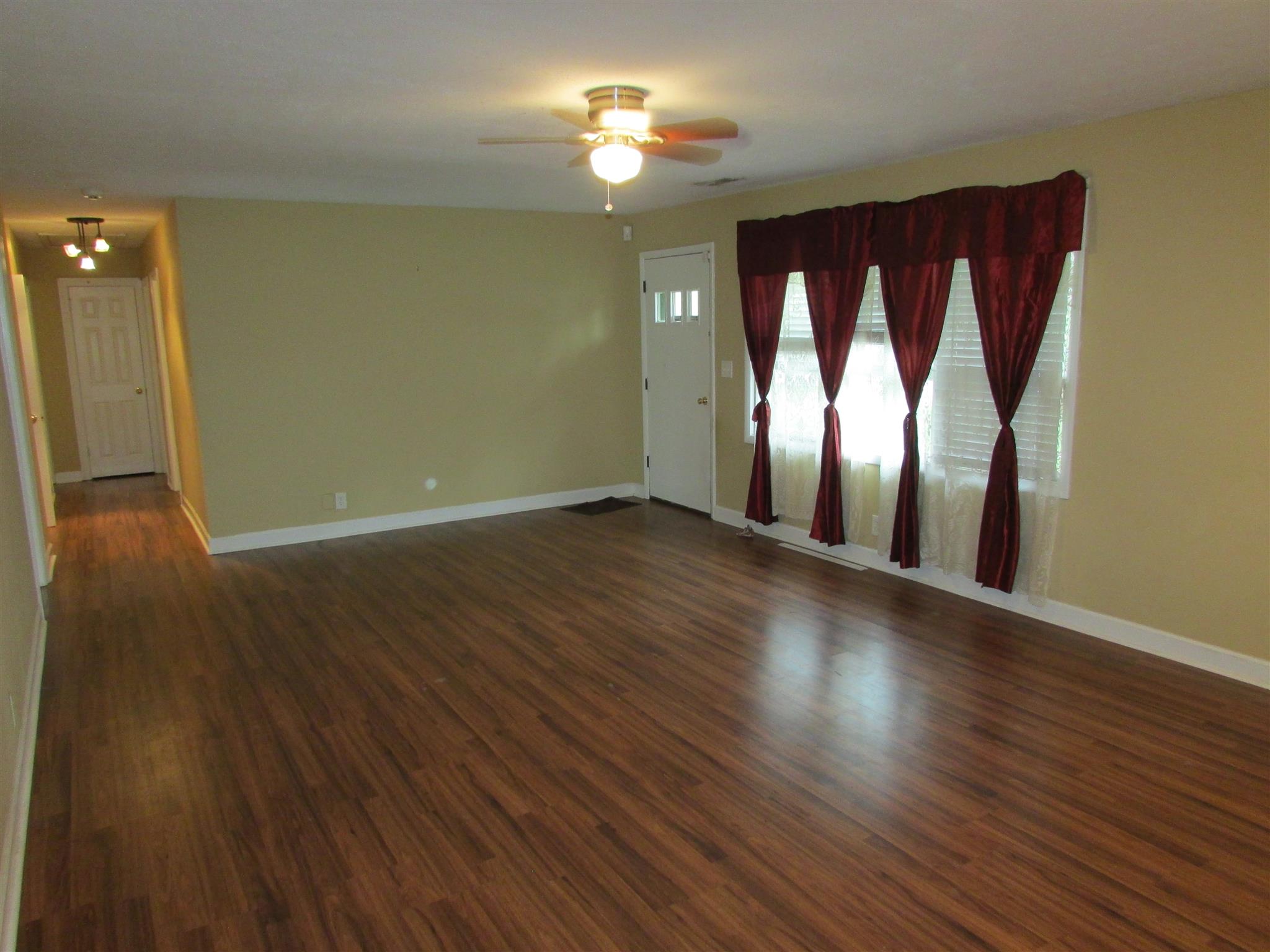 1704 3rd Avenue Manchester, TN 37355 - Photo 2 of 19 a view of wooden floor and windows in a room