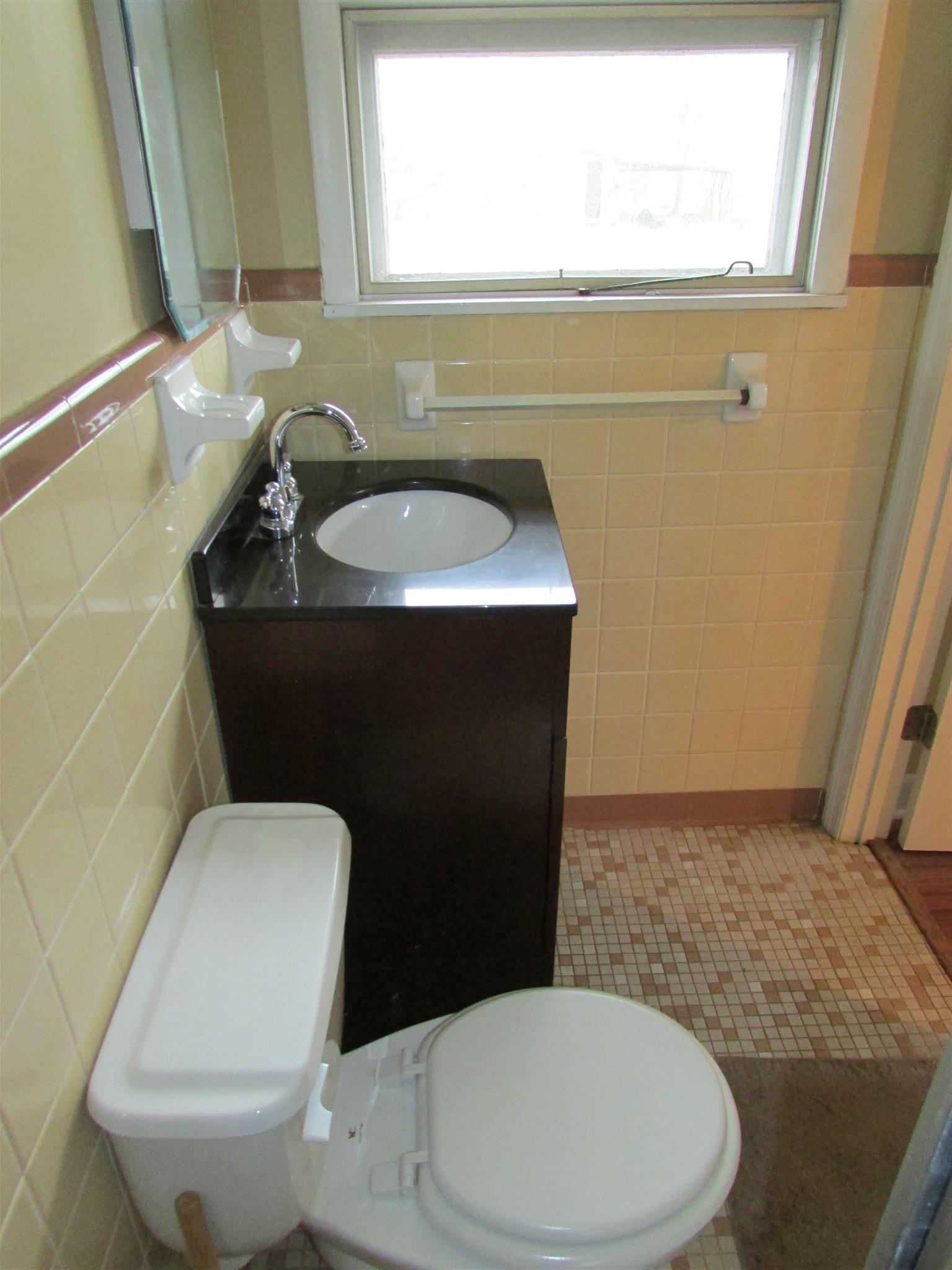 1704 3rd Avenue Manchester, TN 37355 - Photo 15 of 19 a bathroom with a sink a toilet and a mirror