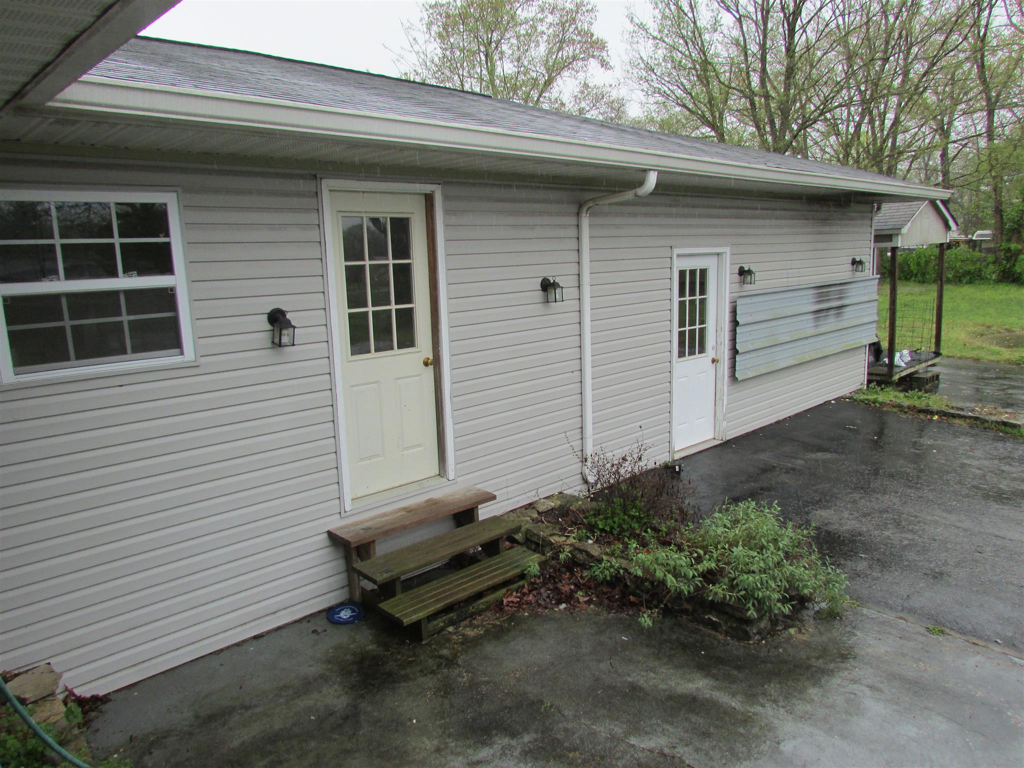 1704 3rd Avenue Manchester, TN 37355 - Photo 17 of 19 a view of a small house with a yard and wooden fence