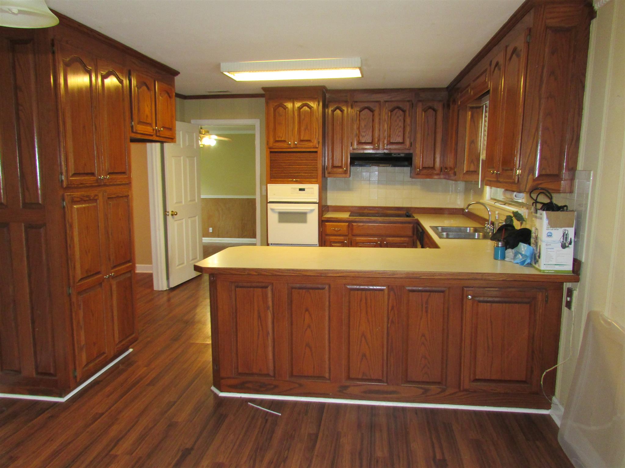 1704 3rd Avenue Manchester, TN 37355 - Photo 3 of 19 a kitchen with wooden floors and wooden cabinets