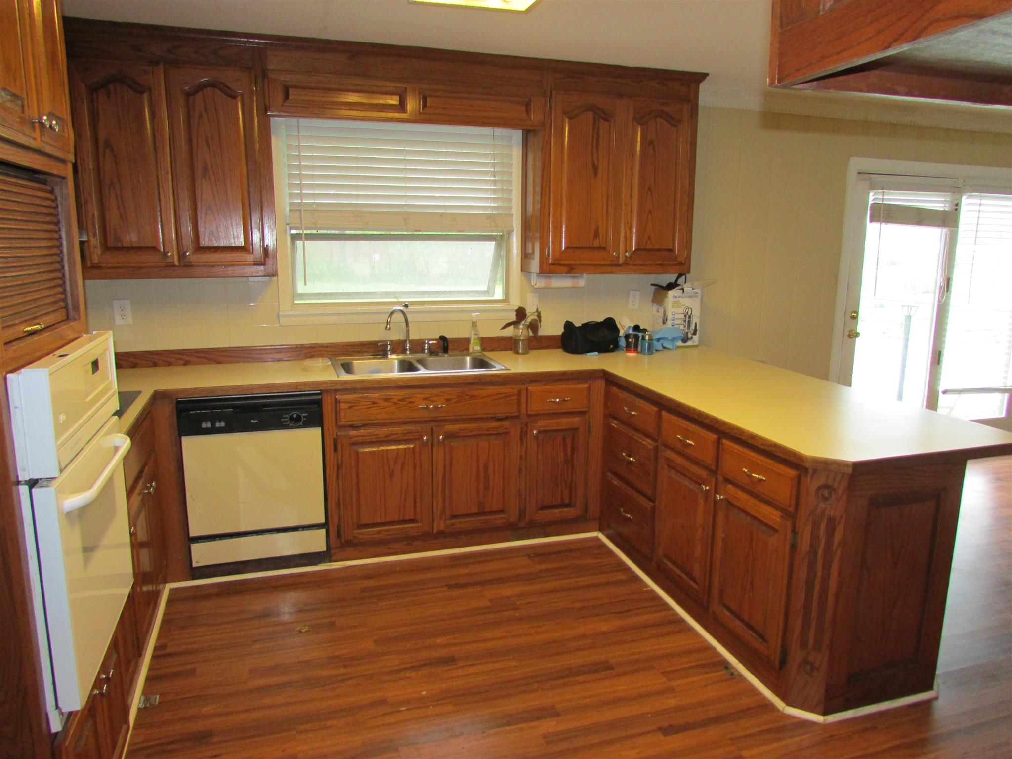 1704 3rd Avenue Manchester, TN 37355 - Photo 4 of 19 a kitchen with stainless steel appliances granite countertop wooden cabinets a sink a stove a refrigerator with wooden floor and cabinets