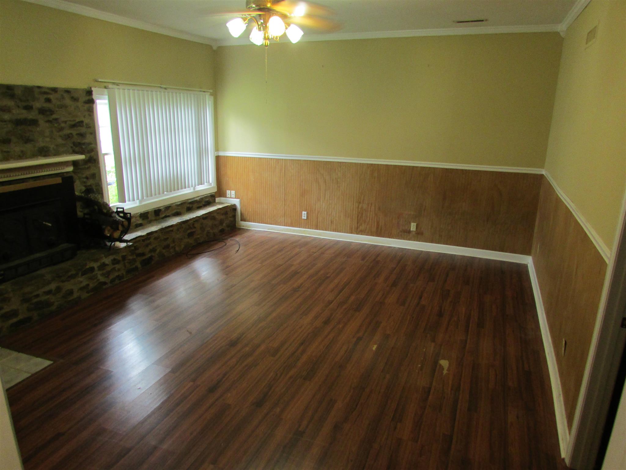 1704 3rd Avenue Manchester, TN 37355 - Photo 6 of 19 an empty room with wooden floor and windows