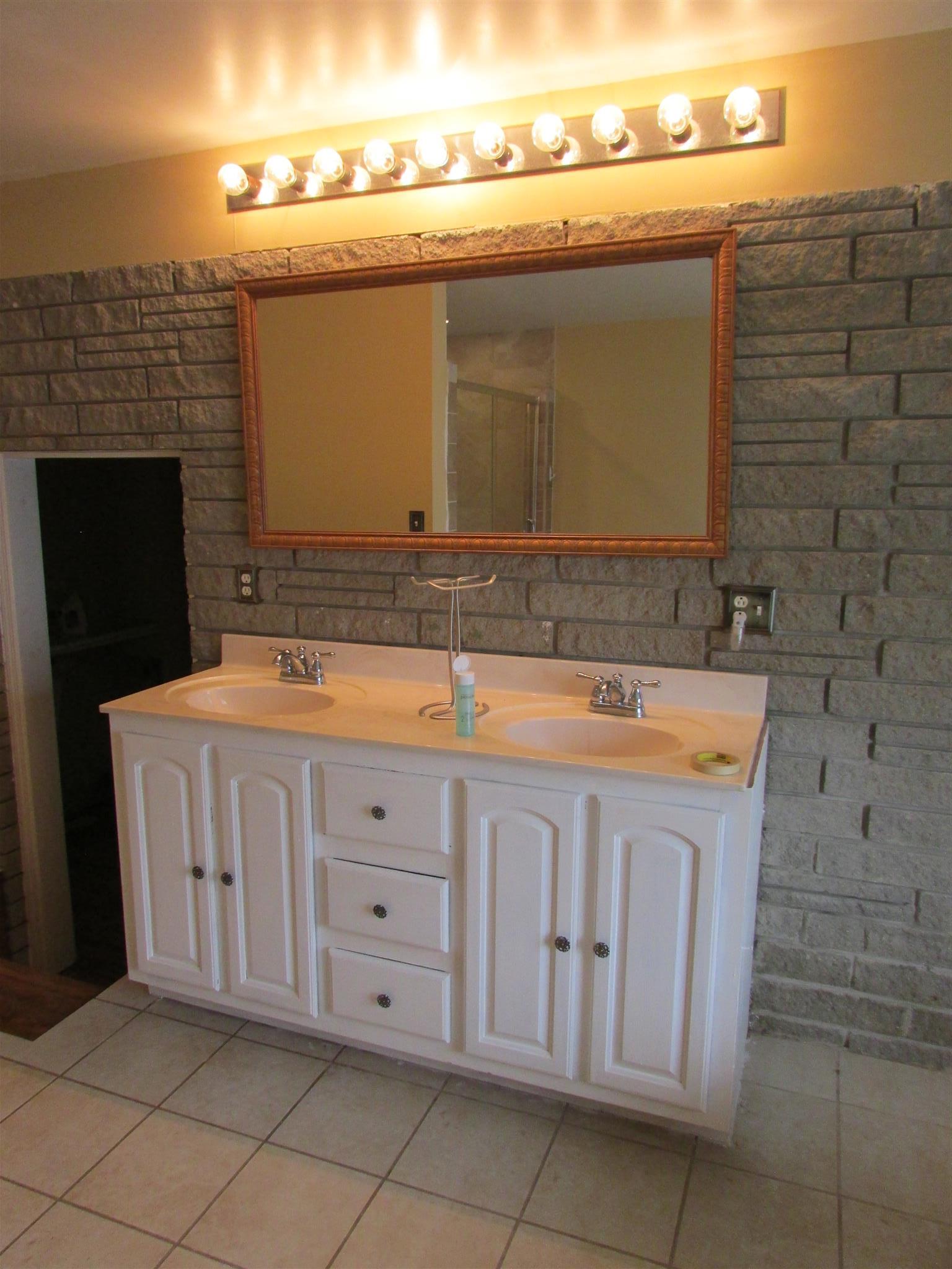 1704 3rd Avenue Manchester, TN 37355 - Photo 9 of 19 a bathroom with a sink a vanity and a mirror