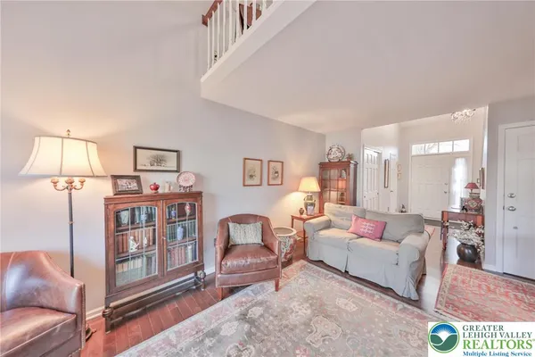 a living room with furniture flowerpot and wooden floor