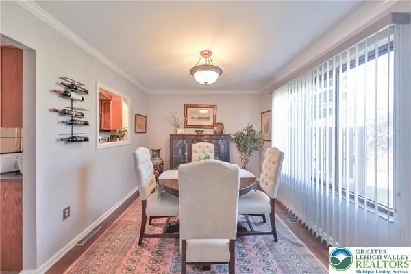 a view of a dining room with furniture and wooden floor