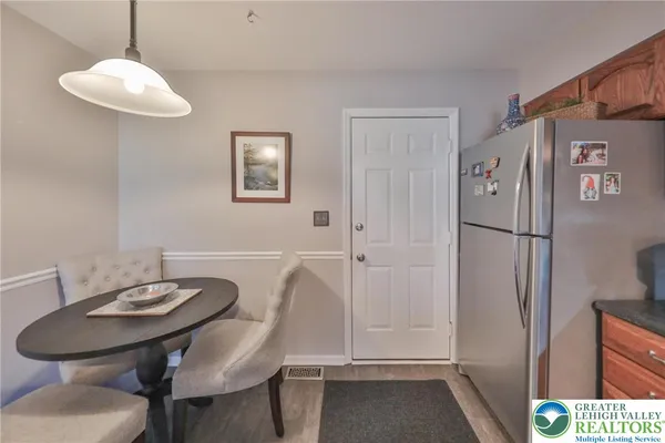 a room with lots of white furniture and a chandelier
