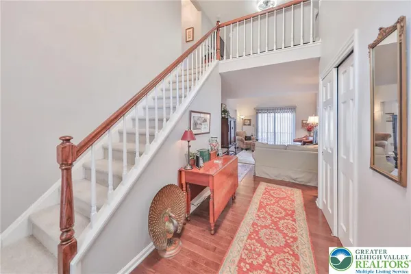 a view of entryway and hall with wooden floor