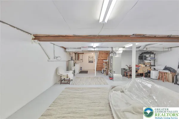 a bedroom with a bed and a table in it next to a window