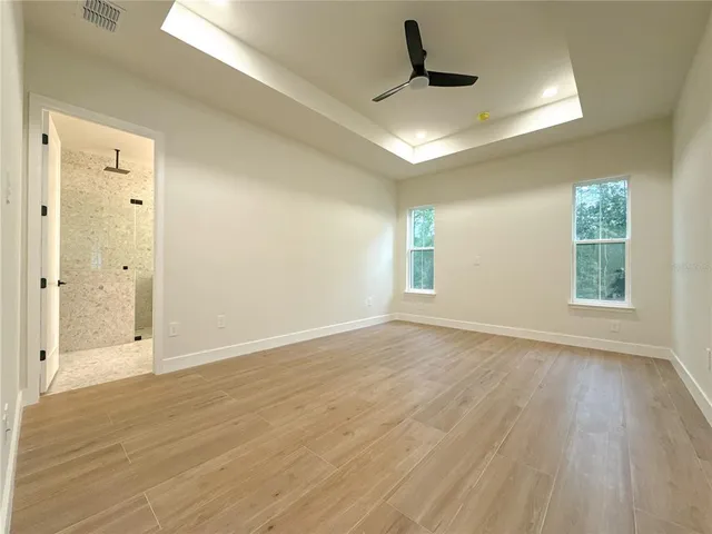 a view of a room with window and wooden floor