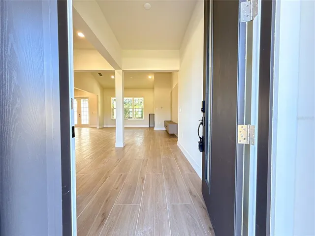 a kitchen with stainless steel appliances kitchen island granite countertop a sink a stove a refrigerator and island with wooden floor