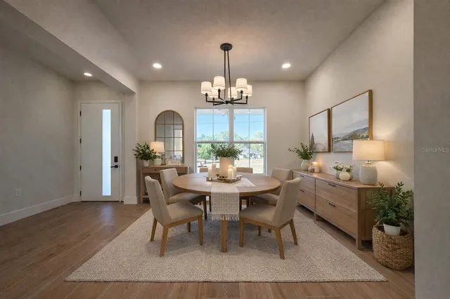 a kitchen with stainless steel appliances granite countertop a refrigerator a stove and a wooden floors