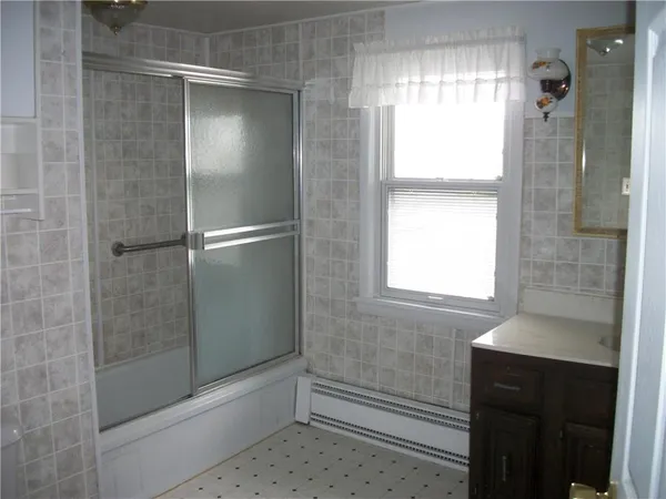 a bathroom with a sink shower and a bathtub
