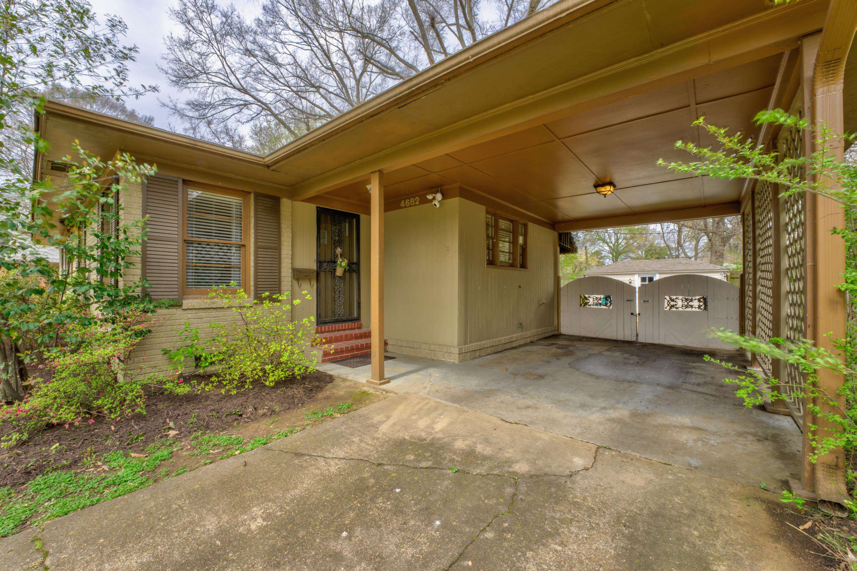 4682 Kaye Road Memphis, TN 38117 - Photo 15 of 17 a view of a house with potted plants and a table and chair