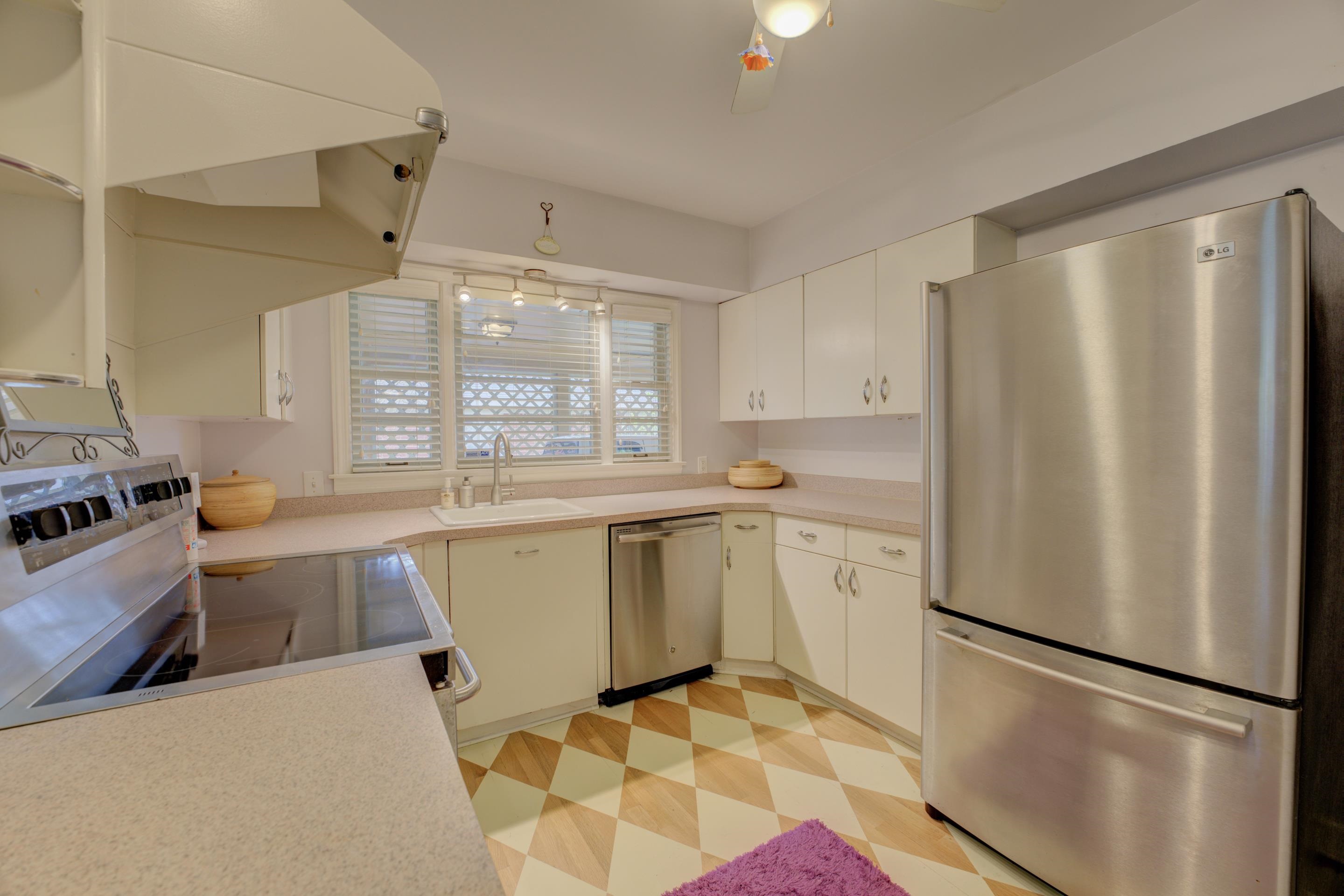 4682 Kaye Road Memphis, TN 38117 - Photo 6 of 17 a kitchen with a refrigerator a sink and white cabinets