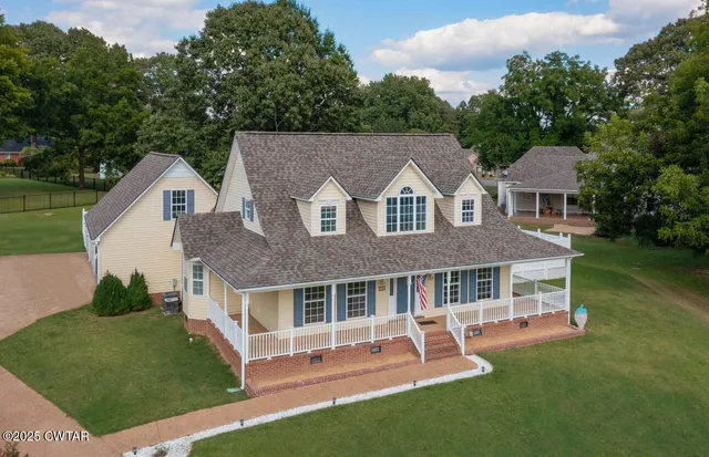 a front view of a house with a yard table and chairs