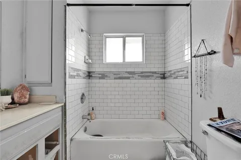 a bathroom with a tub a sink and a window