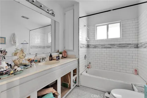 a bathroom with a tub sink and mirror
