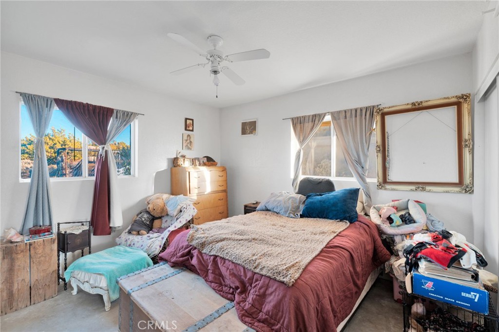 25735 Santa Rosa Road Apple Valley, CA 92308 - Photo 13 of 33 a bedroom with a bed and wooden floor