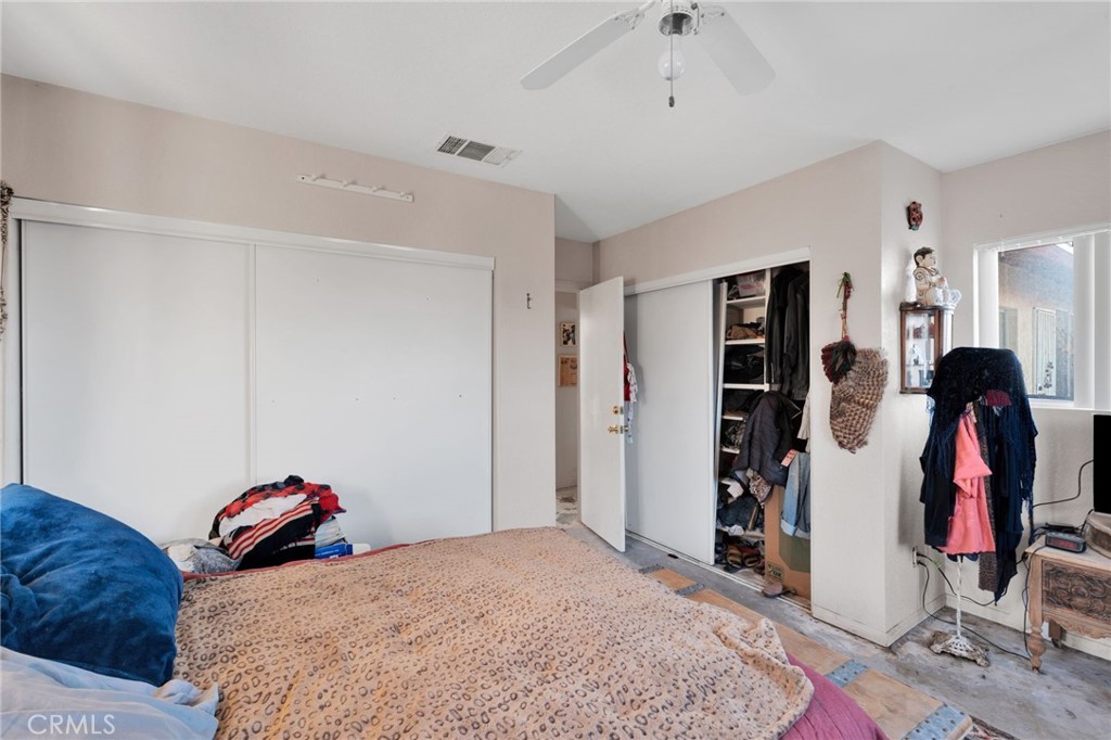 25735 Santa Rosa Road Apple Valley, CA 92308 - Photo 14 of 33 a bedroom with a bed and a walk in closet