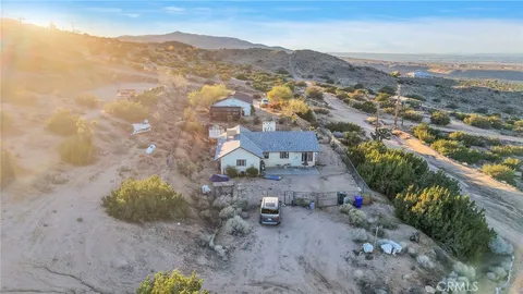 an aerial view of house with yard