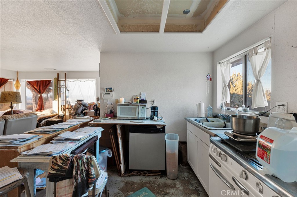 25735 Santa Rosa Road Apple Valley, CA 92308 - Photo 9 of 33 a view of a kitchen with appliances and cabinets