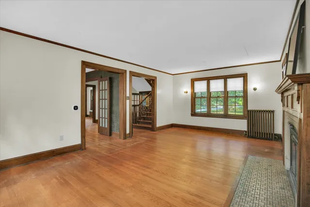 a view of an empty room with glass door and a window