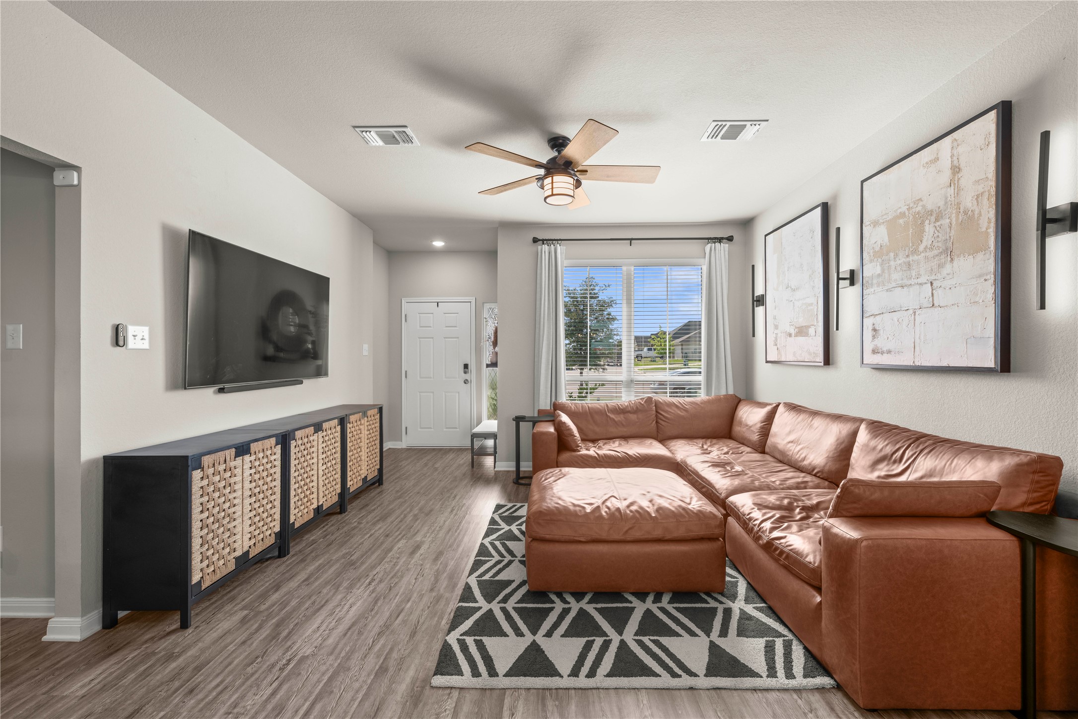 3018 Clevelander Drive Temple, TX 76504 - Photo 13 of 21 a living room with furniture a flat screen tv and a floor to ceiling window
