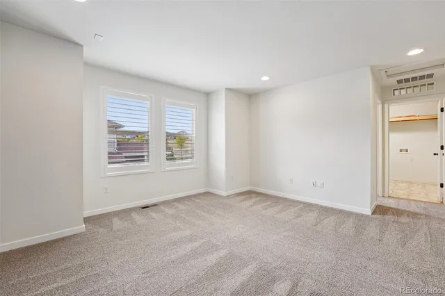 a view of a livingroom with a ceiling fan and window