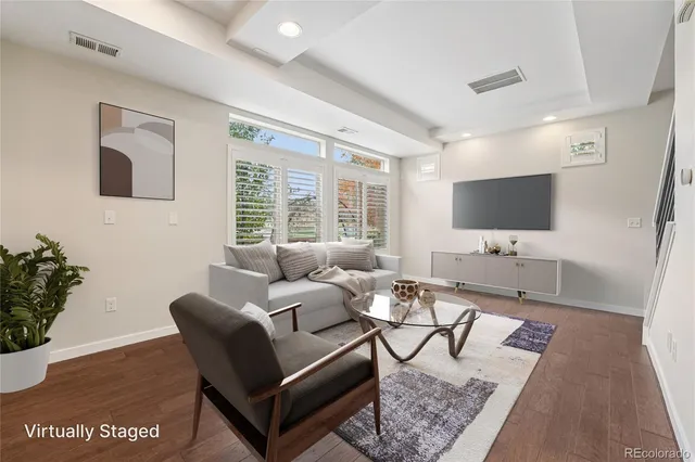 a spacious bedroom with a bed and a flat screen tv