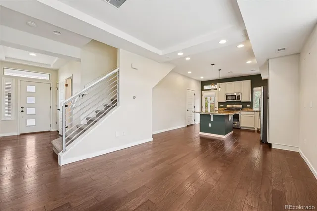 a kitchen with sink refrigerator and microwave