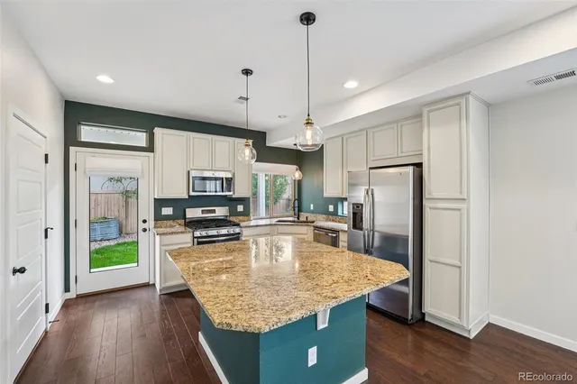 a kitchen with a sink stove and microwave