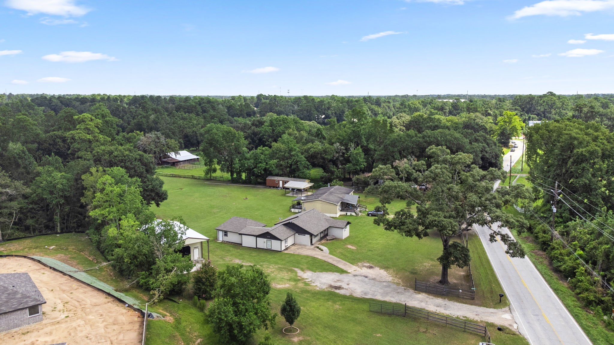25311 Hardin Store Road Pinehurst, TX 77362 - Photo 34 of 39 an aerial view of residential houses with outdoor space and trees