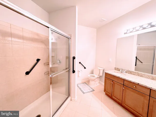 a spacious bathroom with a double vanity sink and a mirror