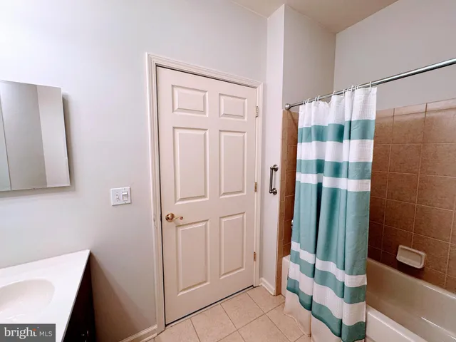 a bathroom with a shower and a sink