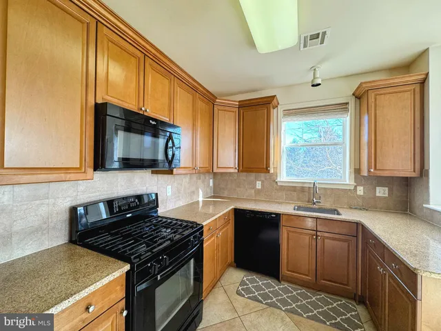 a kitchen with stainless steel appliances a sink stove and microwave
