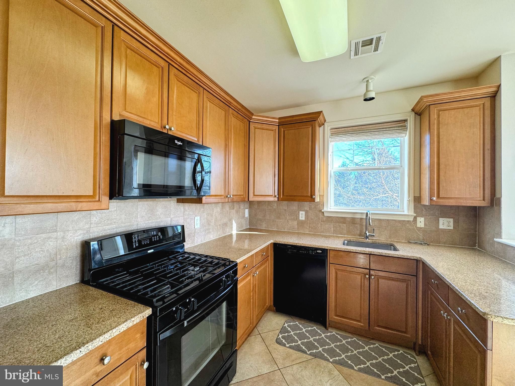 622 Masterson Court Ewing, NJ 08618 - Photo 5 of 26 a kitchen with stainless steel appliances a sink stove and microwave