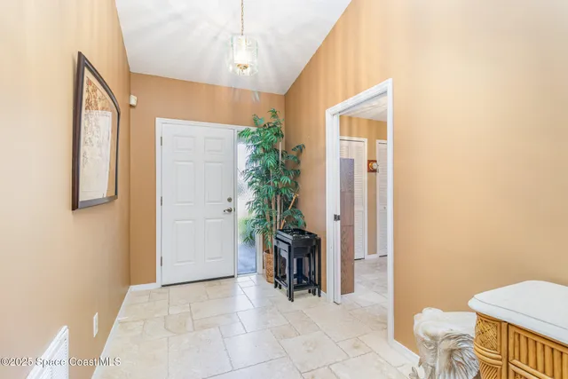 a view of a hallway to dining room and livingroom with furniture
