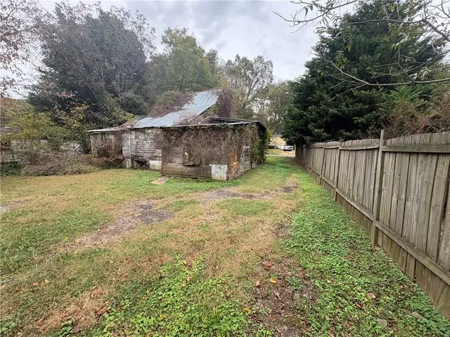 a view of a backyard with a garden and entertaining space