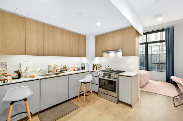 a kitchen with a stove a sink and a refrigerator