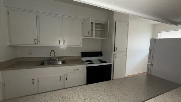 a kitchen with a sink and cabinets